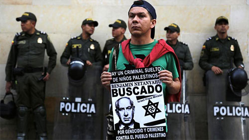 Colombiano sostiene un cartel con el lema “Benjamin Netanyahu: Buscado” Colombianos repudian visita “non grata” de Netanyahu